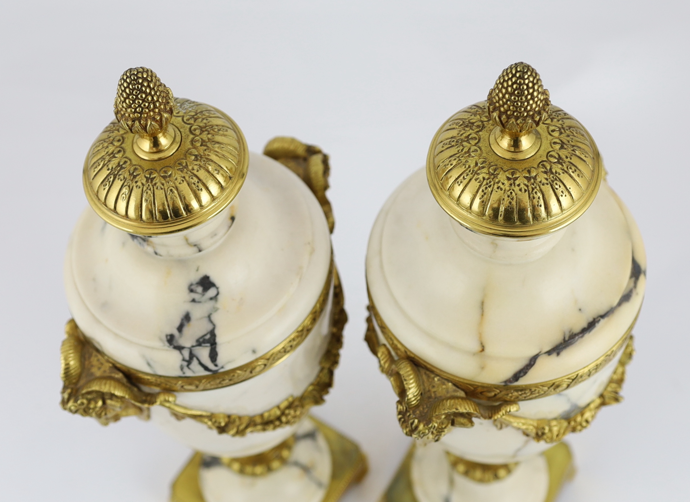 A pair of Italian ormolu mounted calacaita marble urns, 19cm wide, 44cm high